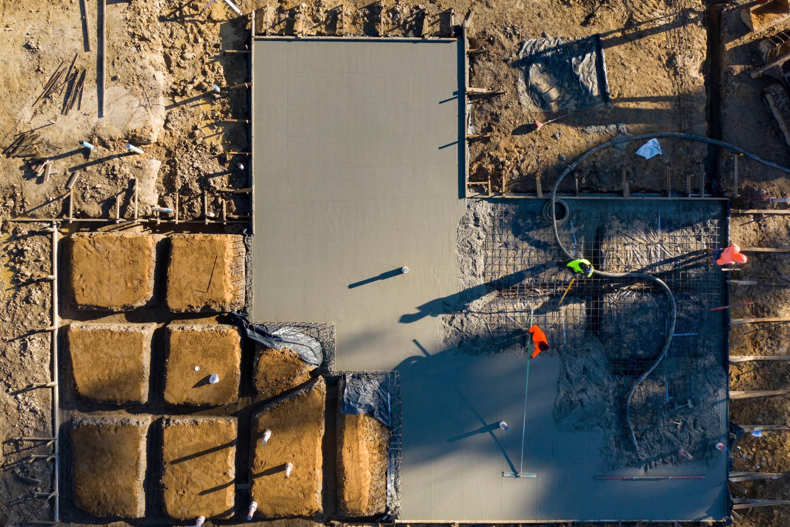 Pouring and leveling a new concrete slab for a residential house under construction in Melbourne Australia