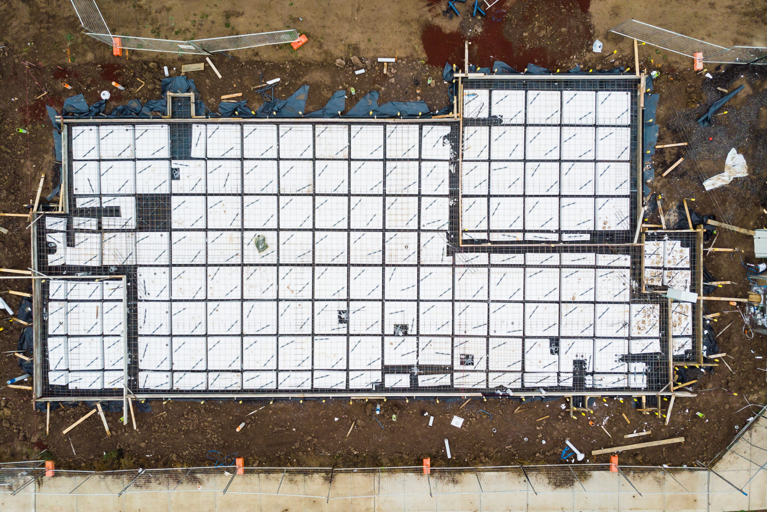 Aerial view of a house in the early stages of construction, prep