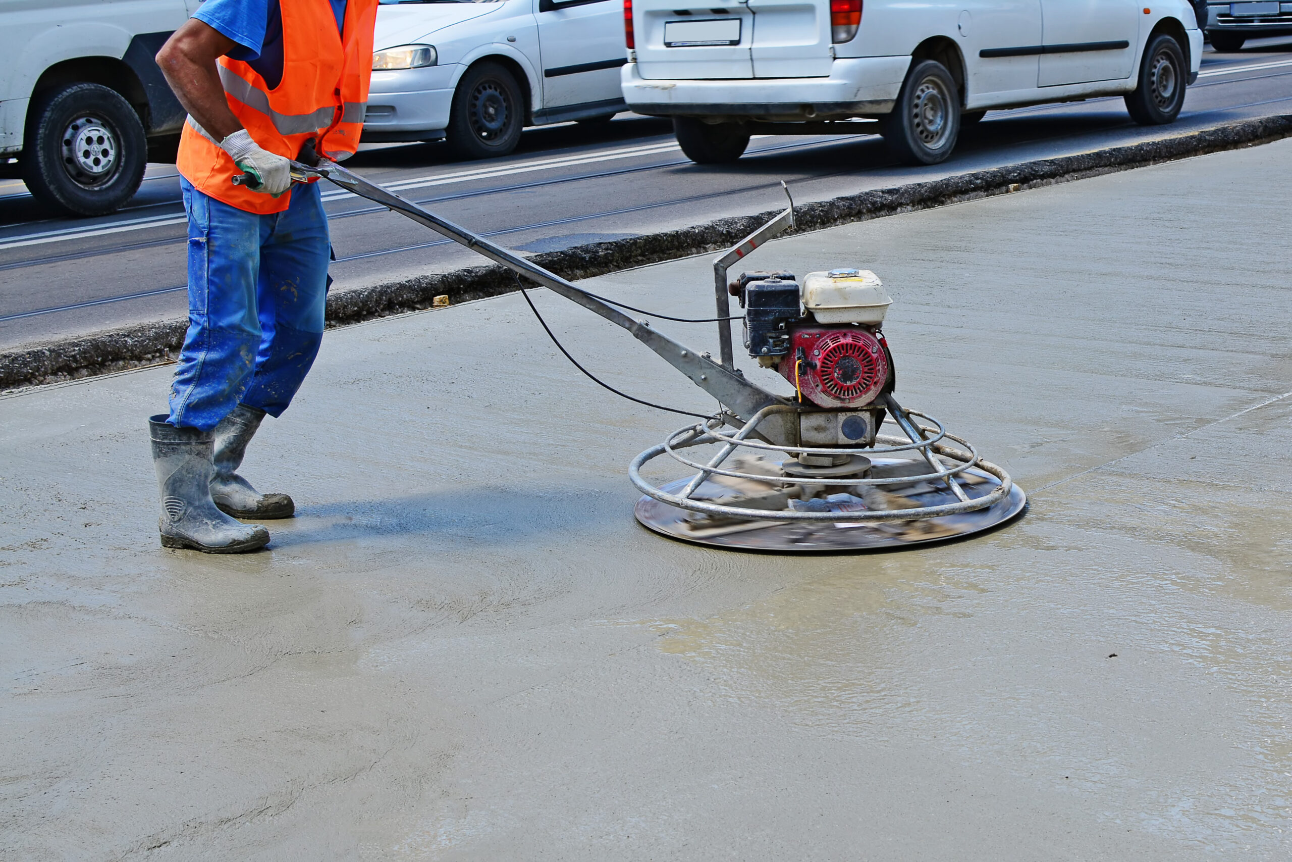 Helicopter concrete finishing. Construction worker finishing concrete with power trowel machine.
